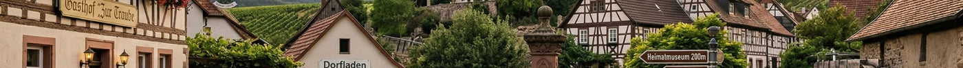 In Dorfmitte am Brunnen versammeln sich Menschen. Unterhalten sich und sind bereit fürs Wandern.